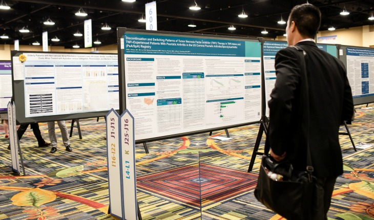 postersWEB AMCP Nexus 2019 - a guest looking at a panel of information.
